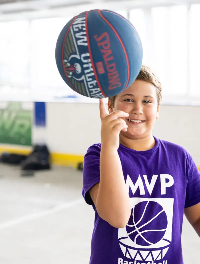 mvp basketball camp schedule - boy spinning basketball